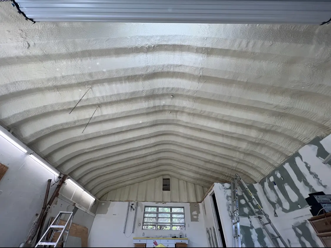 Spray polyurethane foam applied to the underside of a metal roof deck in Omak
